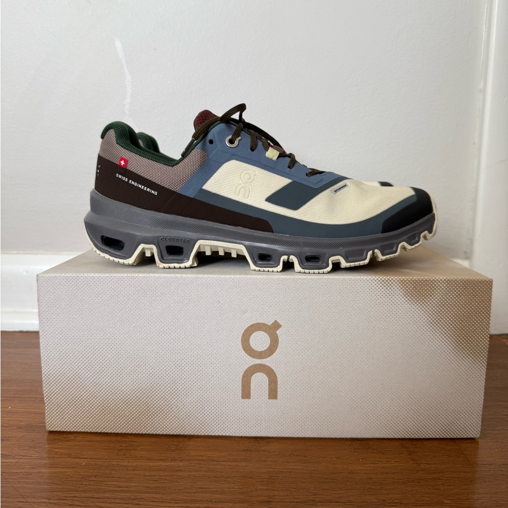 On Running Cream and Blue Athletic Shoes